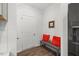 Hallway bench with orange pillows beside fridge at 3800 Cross Timber Ln, Raleigh, NC 27603