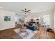 Spacious living room with a blue sofa, stylish rug, and seamless flow to the kitchen at 3800 Cross Timber Ln, Raleigh, NC 27603