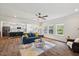 Open-concept living room with a blue sofa, adjacent to a modern kitchen and dining area at 3800 Cross Timber Ln, Raleigh, NC 27603
