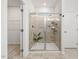 Modern tile shower with glass door, built-in shelving, and plant decoration at 3800 Cross Timber Ln, Raleigh, NC 27603