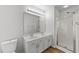 Bathroom featuring a double vanity, framed mirror, hardwood flooring, and a walk-in shower at 3811 Chehaw Dr, Raleigh, NC 27610
