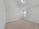 A carpeted bedroom featuring a vaulted ceiling and a window that provides natural light at 3811 Chehaw Dr, Raleigh, NC 27610