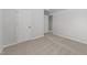 Carpeted bedroom showcasing two doors and neutral walls, creating a calm, inviting space at 3811 Chehaw Dr, Raleigh, NC 27610