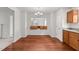 Bright dining area featuring hardwood floors, modern light fixture, and pass-through to the kitchen at 3811 Chehaw Dr, Raleigh, NC 27610