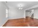 Spacious dining area showcasing hardwood floors, chandelier, and staircase access at 3811 Chehaw Dr, Raleigh, NC 27610