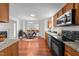 Modern kitchen featuring stainless steel appliances, granite countertops, and wood cabinets at 3811 Chehaw Dr, Raleigh, NC 27610