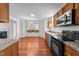 Modern kitchen featuring stainless steel appliances, granite countertops, and wood cabinets at 3811 Chehaw Dr, Raleigh, NC 27610