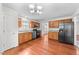 Well-lit kitchen with stainless steel appliances, wood cabinets, and a view of the dining area at 3811 Chehaw Dr, Raleigh, NC 27610