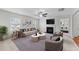 Bright living room with a fireplace, TV, modern furniture, and plenty of natural light at 3811 Chehaw Dr, Raleigh, NC 27610