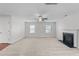 Open-concept living room with carpet, a fireplace, and a ceiling fan at 3811 Chehaw Dr, Raleigh, NC 27610