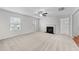 Bright living room featuring a fireplace, neutral carpet, ceiling fan, and natural light at 3811 Chehaw Dr, Raleigh, NC 27610