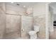 Bathroom featuring a tiled walk-in shower with a mosaic tile accent and a modern toilet at 4 Tocuvan Pl, Durham, NC 27705
