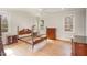 Spacious bedroom with hardwood floors, crown molding, ceiling fan, and windows providing ample natural light at 4 Tocuvan Pl, Durham, NC 27705