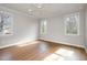 Bright bedroom features hardwood floors, crown molding, and windows providing ample natural light at 4 Tocuvan Pl, Durham, NC 27705