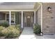 Charming front porch with brick columns and well-maintained landscaping at 4 Tocuvan Pl, Durham, NC 27705