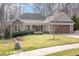 Charming one-story brick home with a well-manicured lawn and inviting front porch at 4 Tocuvan Pl, Durham, NC 27705