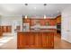 Spacious kitchen features custom wood cabinets, granite countertops, and stainless steel appliances at 4 Tocuvan Pl, Durham, NC 27705