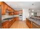 Gourmet kitchen with stainless steel appliances, granite countertops, and custom wood cabinetry at 4 Tocuvan Pl, Durham, NC 27705