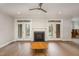 Living room with a fireplace and French doors leading to the outdoor area at 4 Tocuvan Pl, Durham, NC 27705