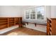 Bright office space features built-in bookshelves and a worktop under a large window overlooking the yard at 4 Tocuvan Pl, Durham, NC 27705