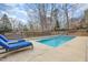 Private backyard pool with lounge chairs and mature trees at 4 Tocuvan Pl, Durham, NC 27705