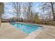 Backyard in-ground pool featuring an expansive pool deck at 4 Tocuvan Pl, Durham, NC 27705