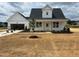 Charming white two-story home with a front-facing garage and freshly landscaped yard and mulched flowerbeds at 432 Springtooth Dr, Zebulon, NC 27597