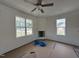 Cozy living room featuring large windows for natural light and a corner fireplace, ready for customization at 432 Springtooth Dr, Zebulon, NC 27597