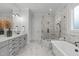 Modern bathroom featuring marble floors, gray cabinets, and a large glass shower at 4508 Chandler Creek Pl, Apex, NC 27539