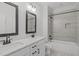 Stylish bathroom with double sinks, white cabinets and a modern walk-in shower at 4508 Chandler Creek Pl, Apex, NC 27539
