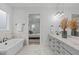 Bright bathroom features a soaking tub and double vanities leading to the bedroom at 4508 Chandler Creek Pl, Apex, NC 27539