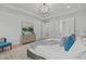 Bright bedroom with a tray ceiling, a chandelier, light hardwood floors and ensuite bath at 4508 Chandler Creek Pl, Apex, NC 27539