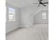 Spacious bonus room with neutral carpet, ceiling fan, and lots of natural light at 4508 Chandler Creek Pl, Apex, NC 27539