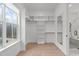 Spacious walk-in closet with custom shelves and a mirror at 4508 Chandler Creek Pl, Apex, NC 27539