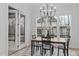 Cozy dining area with a view of the backyard, featuring a chandelier and access to an outdoor space at 4508 Chandler Creek Pl, Apex, NC 27539