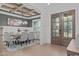Elegant dining room with a coffered ceiling, stylish chandelier, and a gray accent wall with wainscoting at 4508 Chandler Creek Pl, Apex, NC 27539