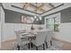 Elegant dining room with a coffered ceiling, stylish chandelier, and a gray accent wall with wainscoting at 4508 Chandler Creek Pl, Apex, NC 27539