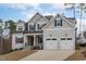 Charming two-story home with a two-car garage, covered entry, and meticulously landscaped yard at 4508 Chandler Creek Pl, Apex, NC 27539