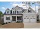 Traditional two-story home featuring a two-car garage, a covered entryway, and professional landscaping at 4508 Chandler Creek Pl, Apex, NC 27539