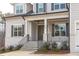 Charming home featuring an inviting front porch, well-kept landscaping and an elegant, glass-paneled front door at 4508 Chandler Creek Pl, Apex, NC 27539