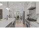 Modern kitchen featuring stainless steel appliances, gray cabinets, and an adjacent dining area with natural light at 4508 Chandler Creek Pl, Apex, NC 27539