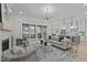 Bright living room with a fireplace, hardwood floors, stylish furniture and sliding glass doors to the back patio at 4508 Chandler Creek Pl, Apex, NC 27539
