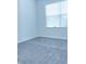 A bright, carpeted bedroom featuring a window offering natural light and a serene ambiance at 4914 Arkose Dr, Raleigh, NC 27610