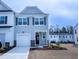 Charming two-story home featuring blue siding, a one-car garage, and manicured landscaping at 4914 Arkose Dr, Raleigh, NC 27610