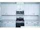 Kitchen featuring white cabinets, stainless steel appliances, and subway tile backsplash at 4914 Arkose Dr, Raleigh, NC 27610