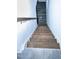 Carpeted stairs ascending to the second floor of the home. The handrail is wood with metal supports at 4914 Arkose Dr, Raleigh, NC 27610