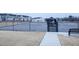 Community tennis court featuring fence and a gazebo with residential homes in the background at 4914 Arkose Dr, Raleigh, NC 27610