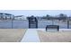 Community tennis court featuring fence and a gazebo with residential homes in the background at 4914 Arkose Dr, Raleigh, NC 27610