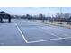 View of the community tennis court featuring new net and fencing at 4914 Arkose Dr, Raleigh, NC 27610