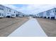 View of the community walking path running between the backs of townhomes at 4914 Arkose Dr, Raleigh, NC 27610